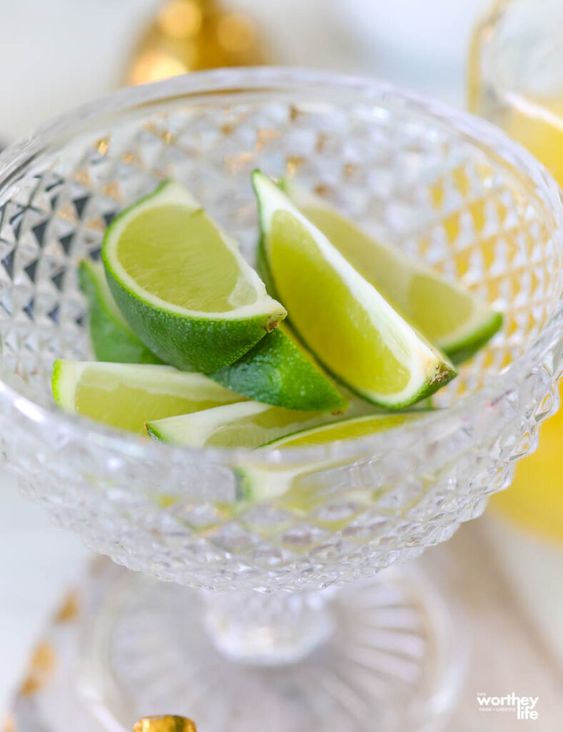 a glass filled with fresh lime wedges