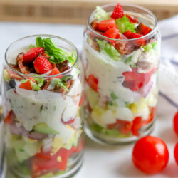 two clear glasses filled with strawberry cobb salad