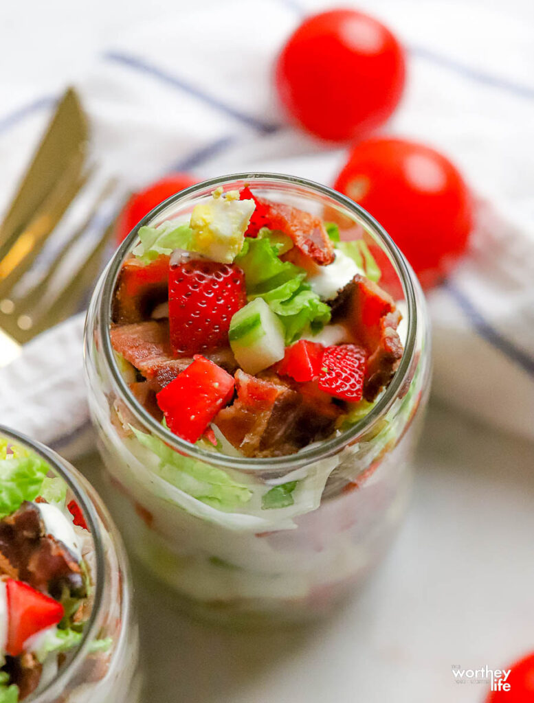summer strawberry cobb salad in a clear glass