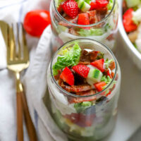 glasses of strawberry cobb salad with utensils
