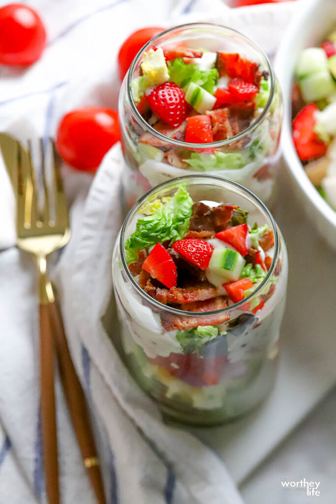 glasses of strawberry cobb salad with utensils
