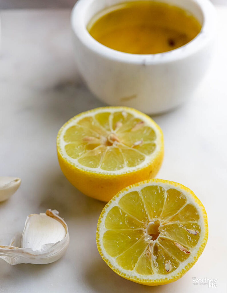 Garlic cloves, a sliced lemon, and olive oil