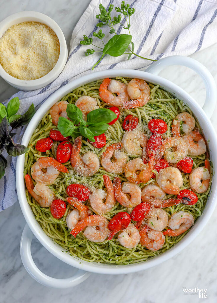 The prepared pesto pasta dish with shrimp and blistered tomatoes