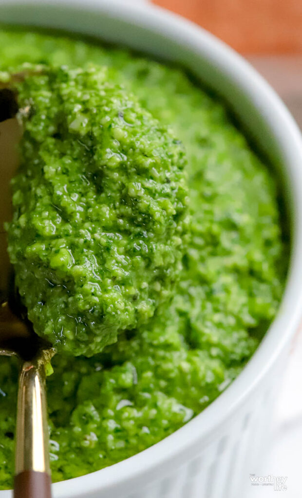 A white porcelain ramekin filled with pesto sauce recipe