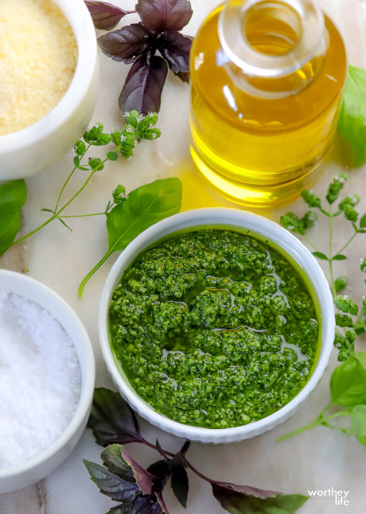 pesto sauce recipe in white bowl with olive oil