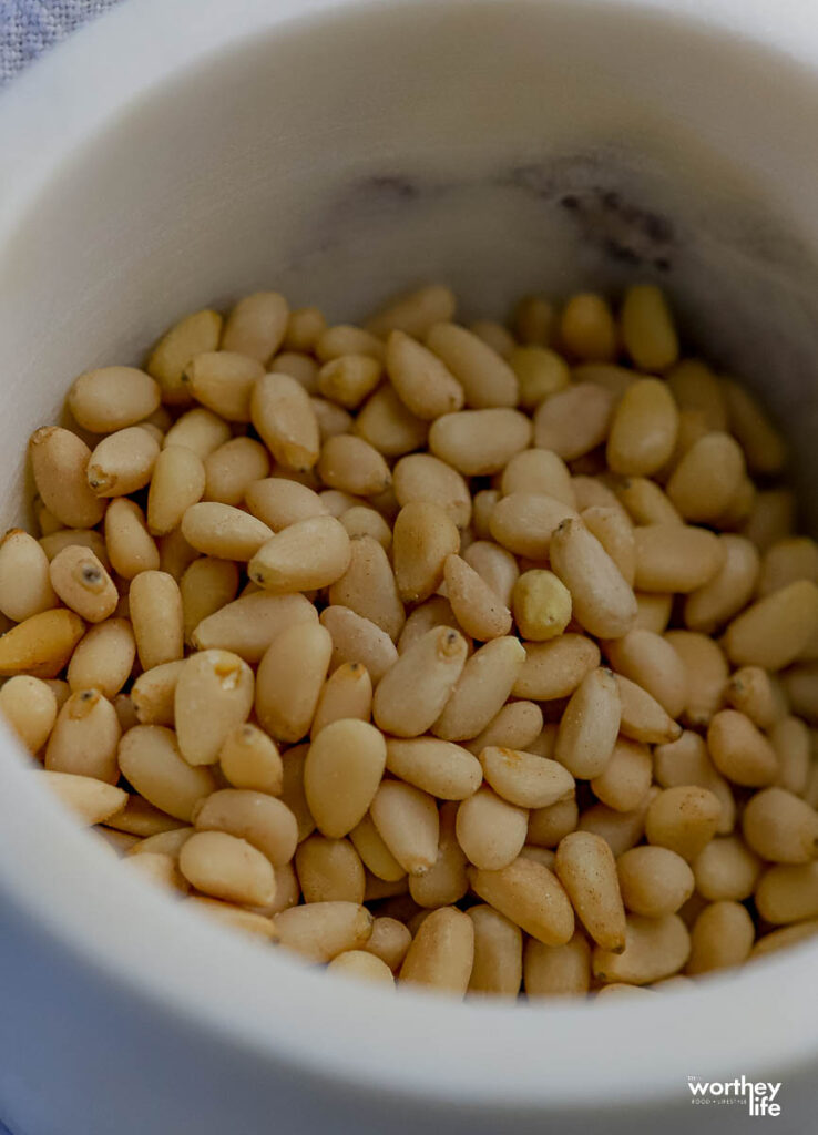 A bowl filled with pine nuts for a pesto sauce recipe