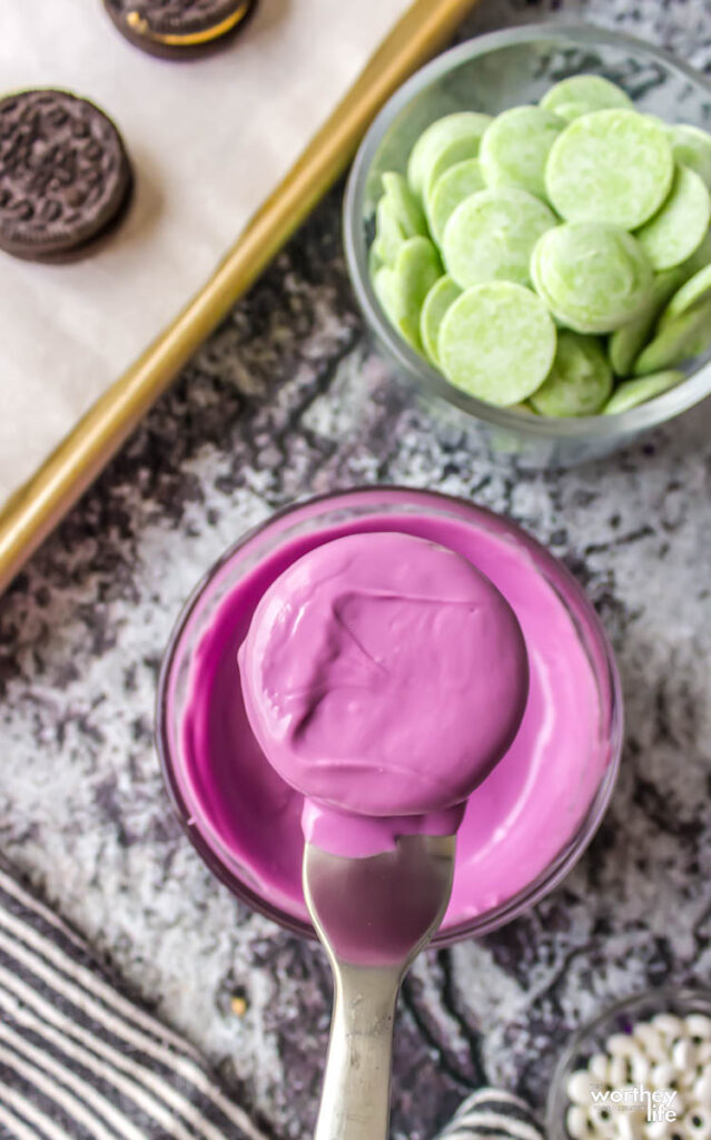 dipping chocolate covered oreos in purple mix