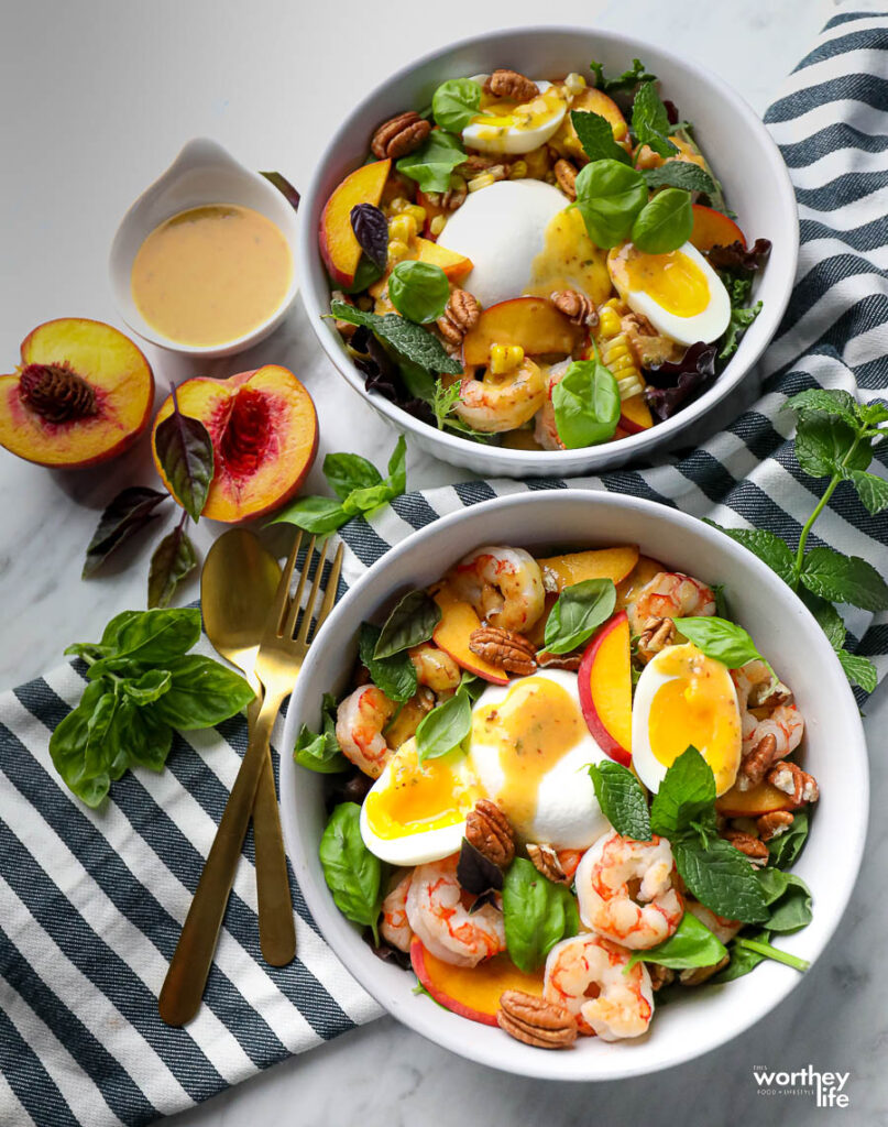 two white salad bowls filled with a freashly made salad