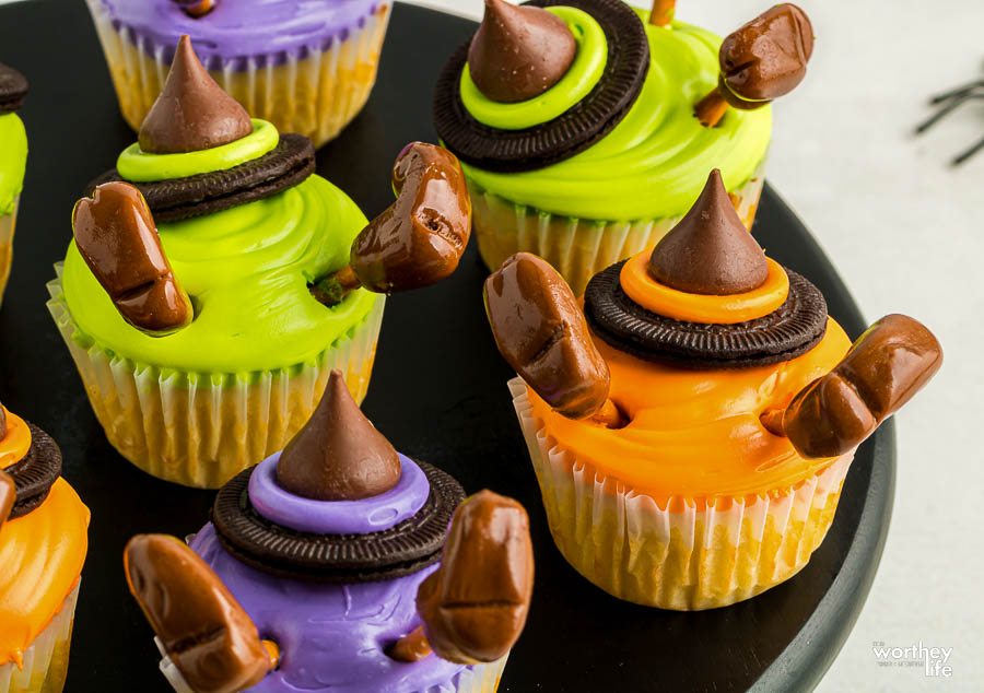 colorful Halloween cupcakes on black plate