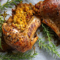 stuffed turkey wings on a plate with sprigs of fresh rosemary