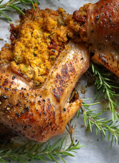 stuffed turkey wings on a plate with sprigs of fresh rosemary