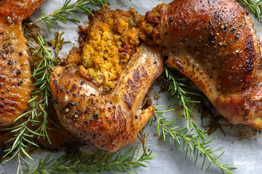 stuffed turkey wings on a plate with sprigs of fresh rosemary