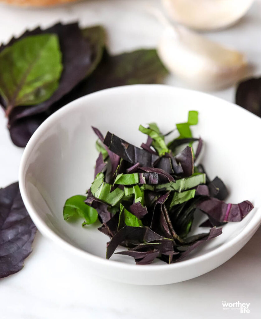 chopped basil in white bowl