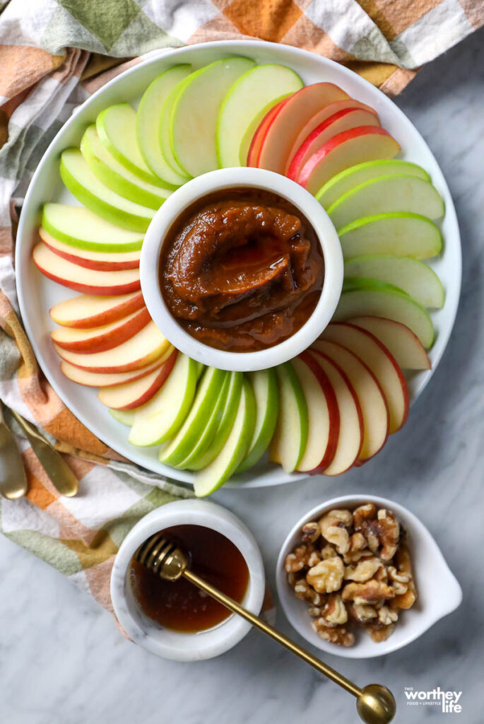 pumpkin in a white ramekin served with apple slices