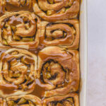 cinnamon rolls with caramel in white baking dish