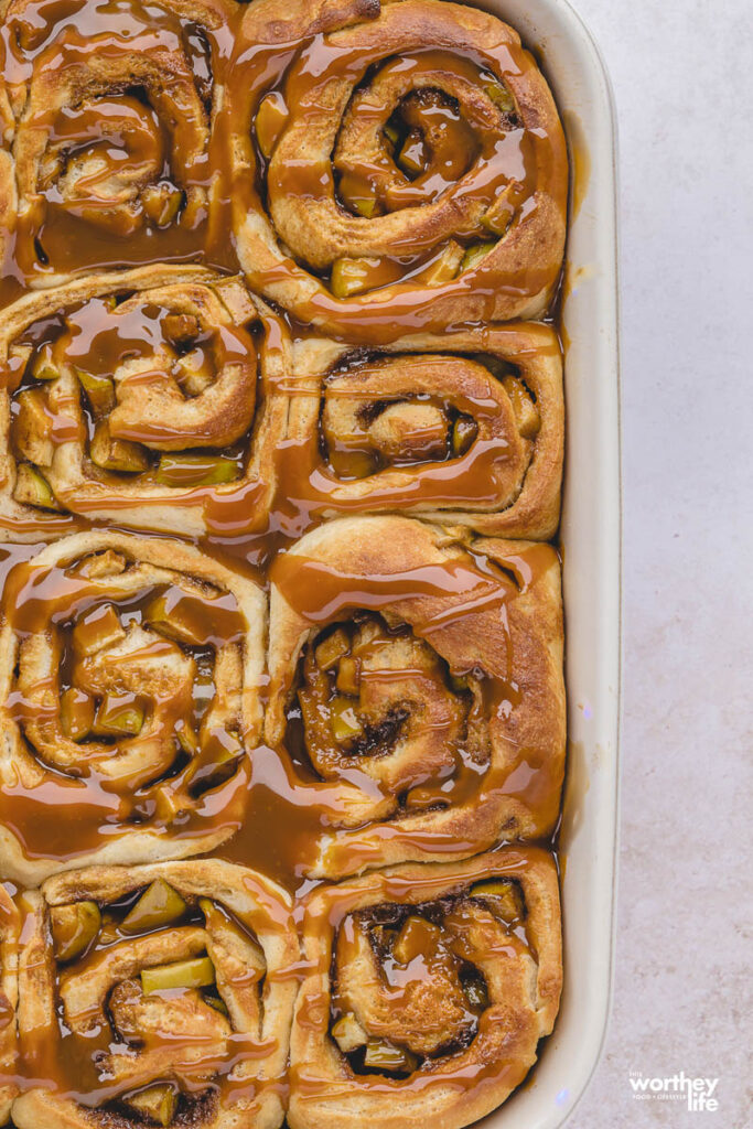 cinnamon rolls with caramel in white baking dish