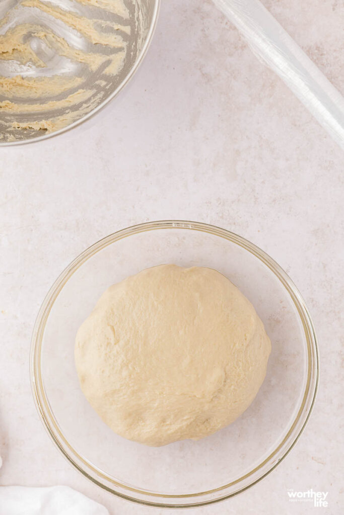 bread dough in glass bowl
