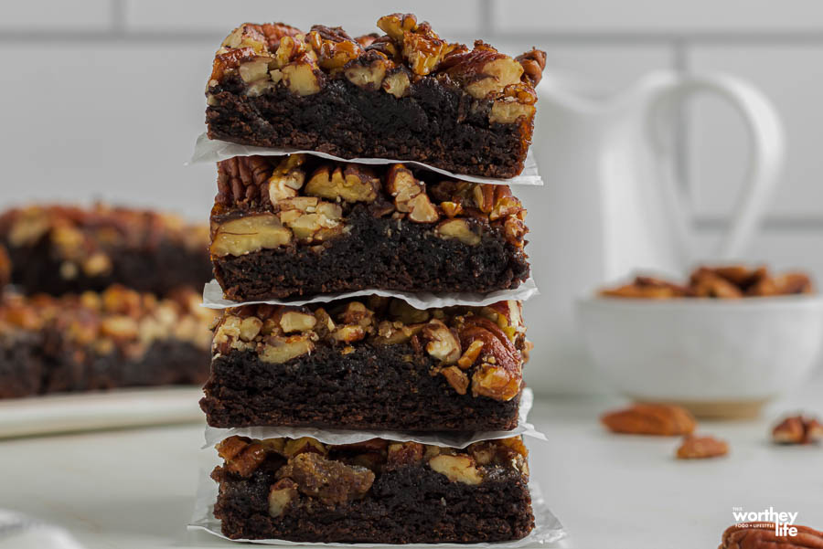 a stack of pecan pie brownies on waxed paper