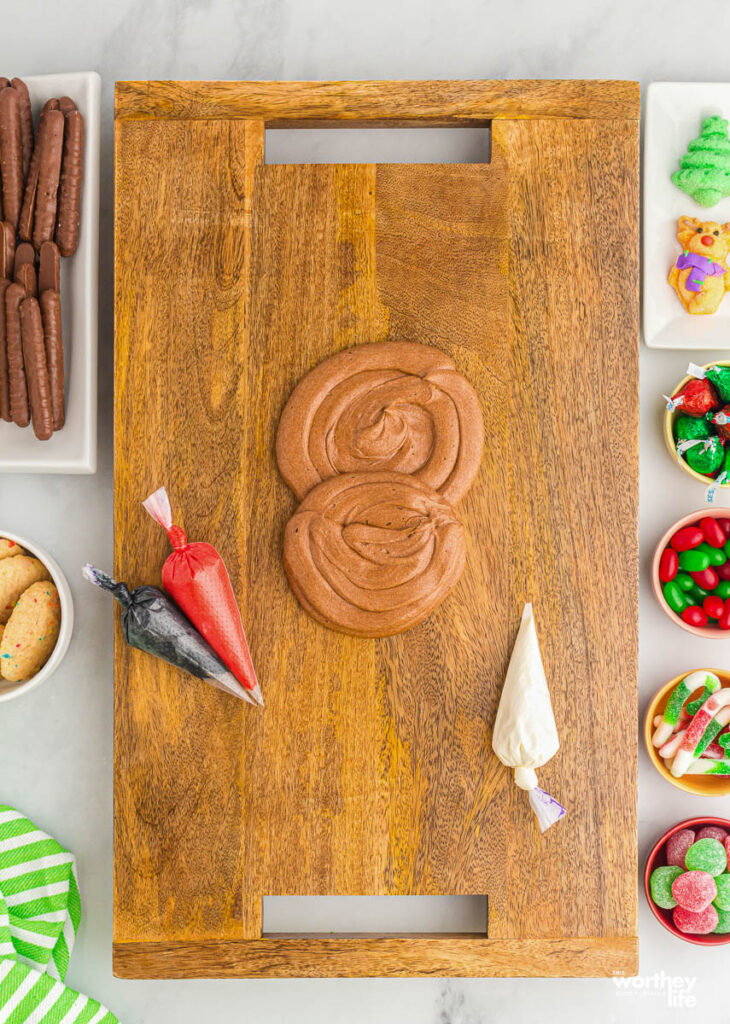 Using chocolate buttercream frosting in piping bag on wooden board