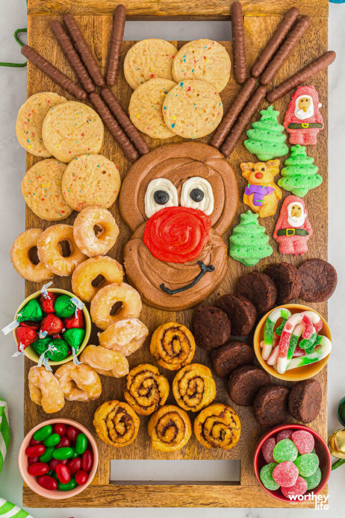How to make a Reindeer Buttercream Board filled with holiday sweets and chocolate buttercream frosting on wooden board