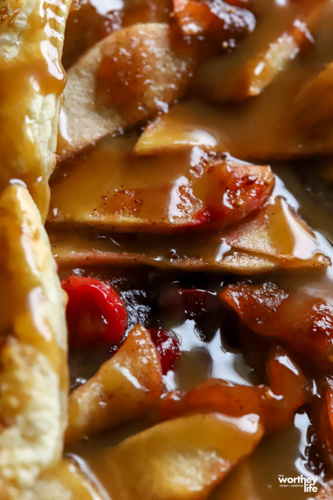 a partial view of a baked apple and cranberry galette. 
