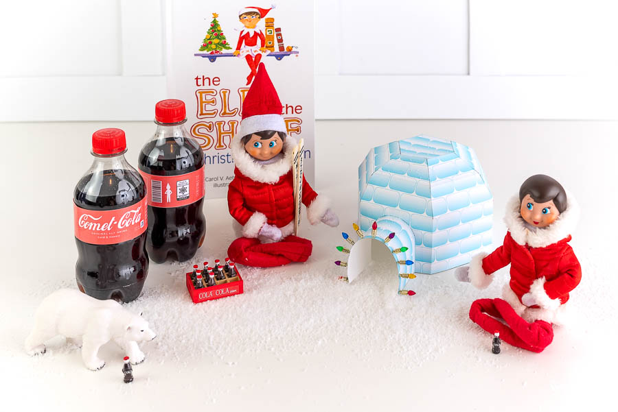Elves sitting by Igloo with Coca Cola
