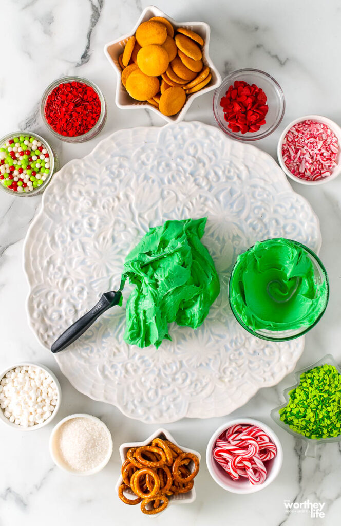 Spreading green frosting on white platter