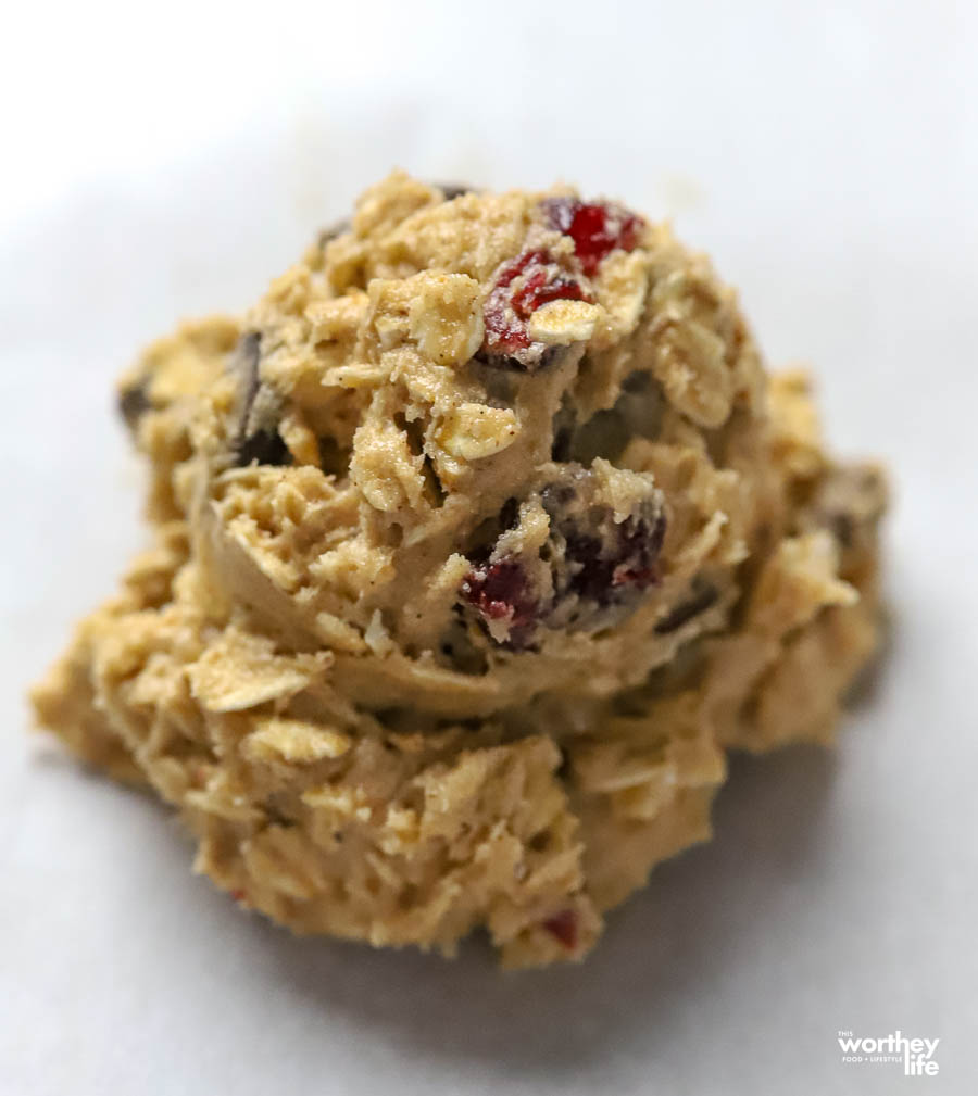 a scoop of cookie dough on parchment paper