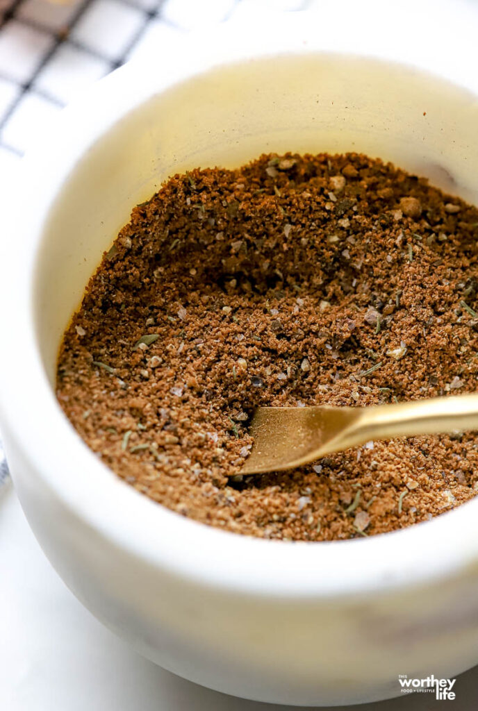 A small white mixing bowl containing the dry Jerk ingredients.