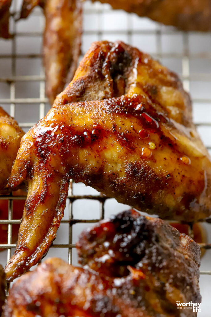 Jerk chicken wings with hot honey on a wire rack. 