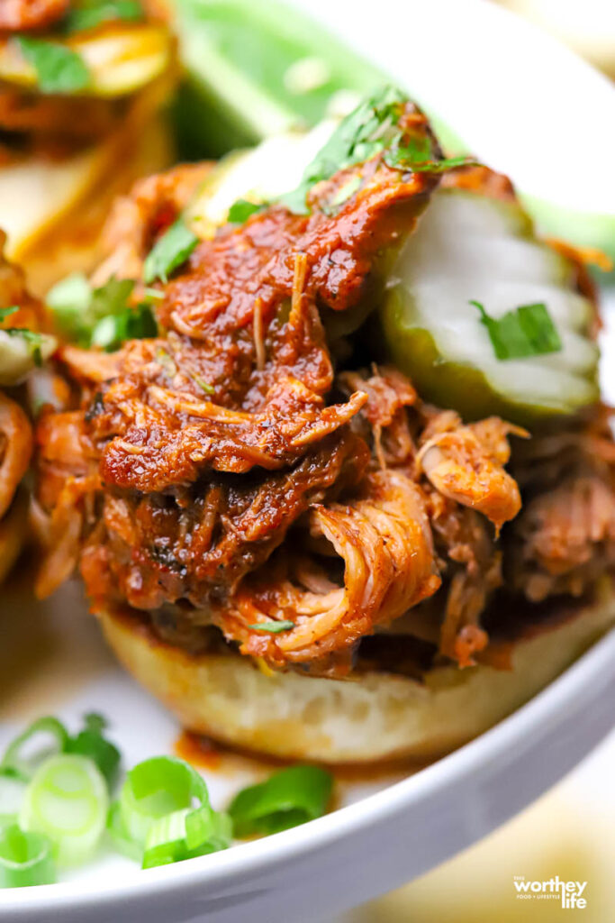 Pork Birria on slider buns with pickles. 