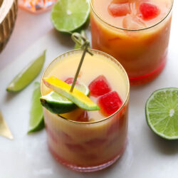 Two Mango Sour cocktails on white marble