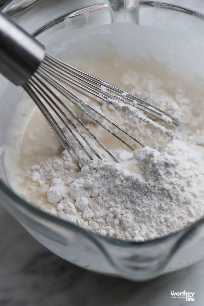 making pancake mix in a large glass bowl