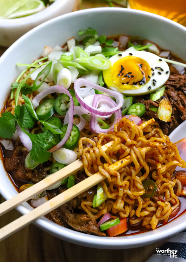 Mexican ramen with toppings in a white bowl