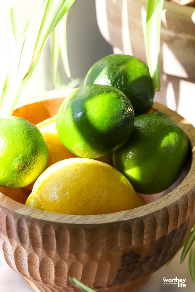 Limes and lemons in wooden bowl