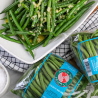 Packages of North Bay Produce French Green Beans and a serving dish with our Honey Garlic Butter Green Beans.