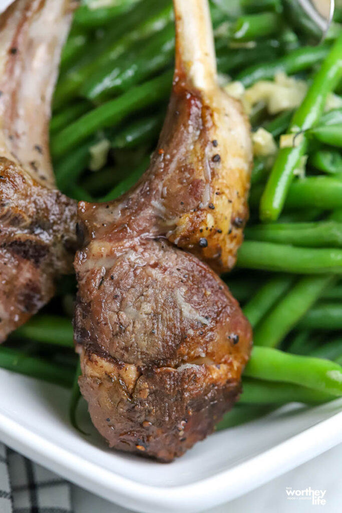 lamb chops served with honey garlic butter French green beans