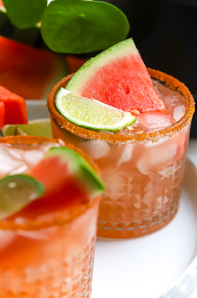 A Watermelon cocktail with fresh watermelon on a white plate