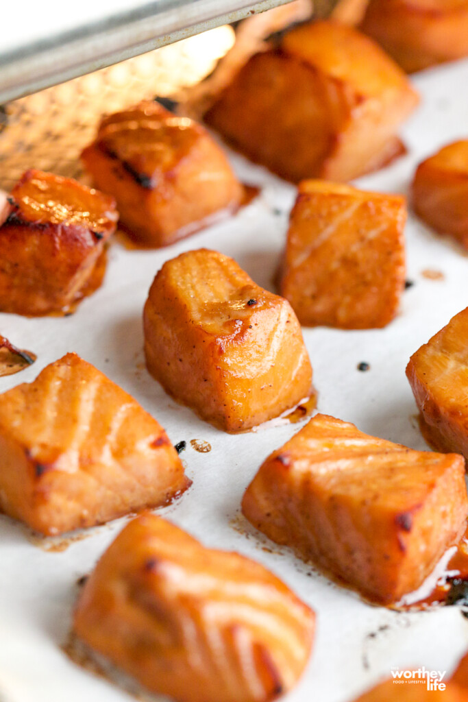 cubes of fresh salmon on air fryer basket tray