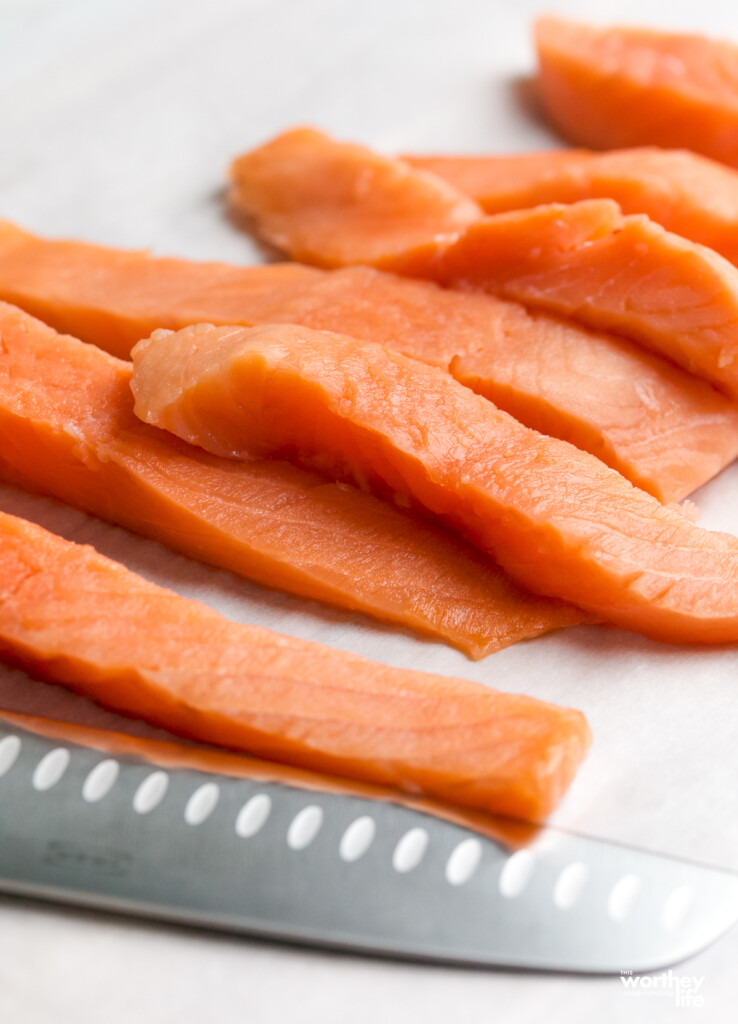 Strips of fresh salmon on a white paper towel