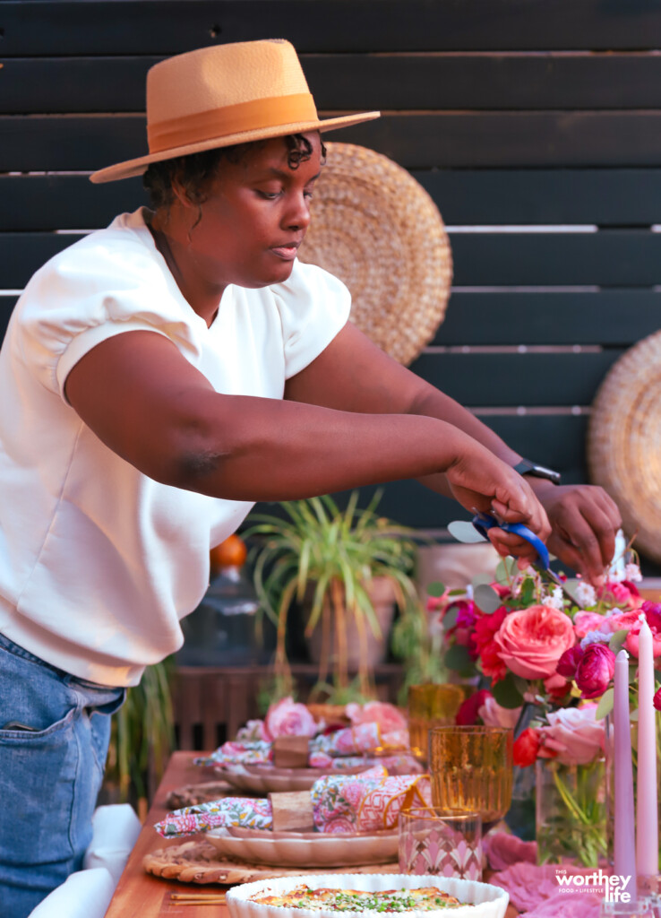 Black woman getting ready to host a Outdoor Spring Brunch Idea