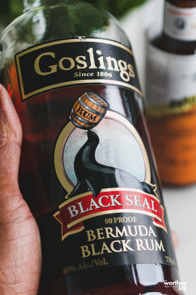 Man holding a bottle of Goslings Bermuda Black Rum