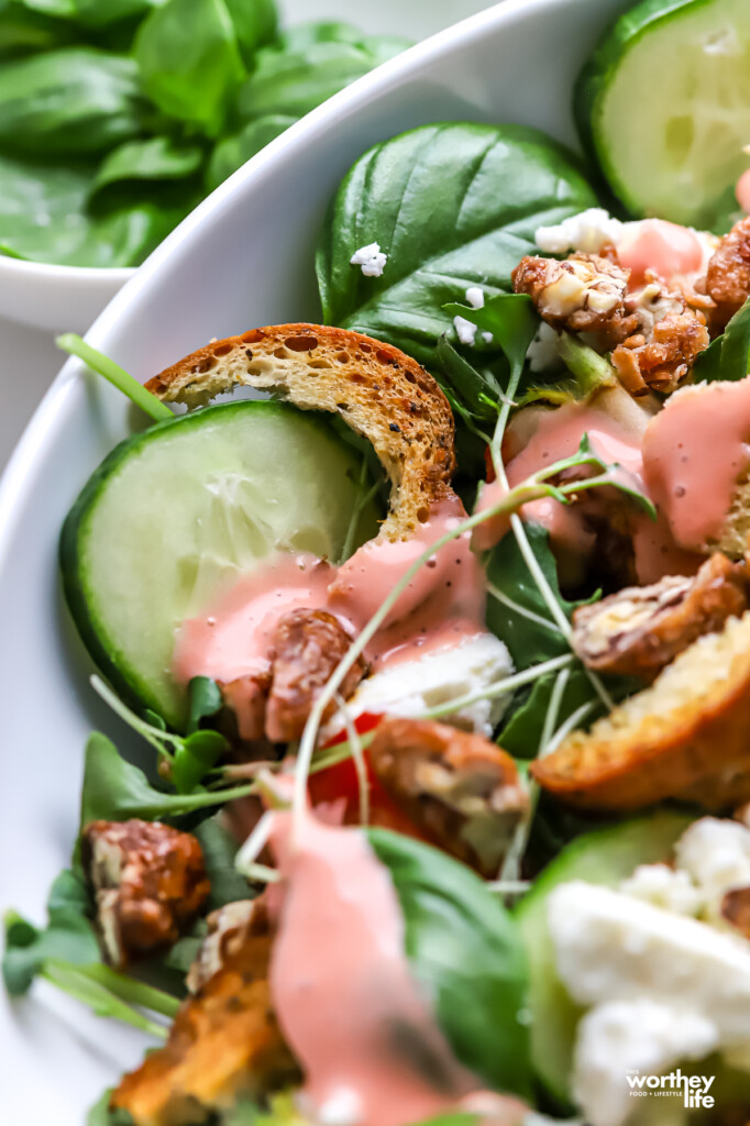 A partial view of our Strawberry Arugula Salad with strawberry vinaigrette and herb bagel croutons. 