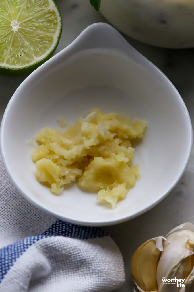 A small white bowl of minced ginger.