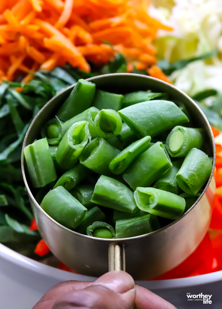 Chopped sugar snap peas in a measuring cup.