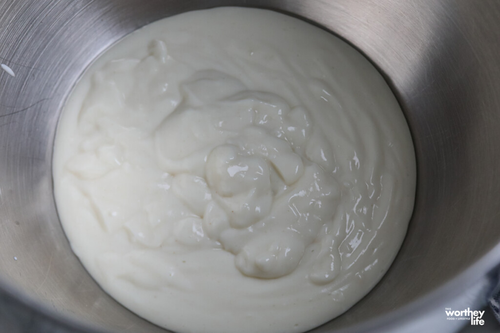 Water roux in the bottom of a metal mixing bowl. 