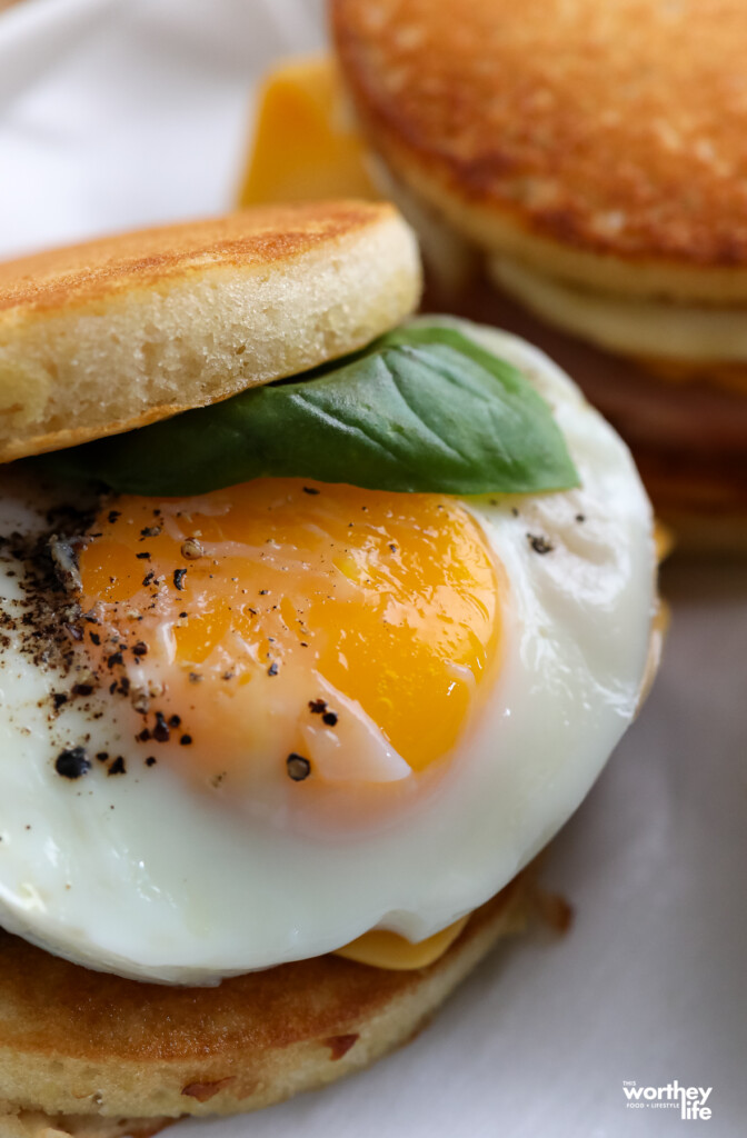 Two McGriddle Copycat Breakfast Sandwiches with sweet basil. 