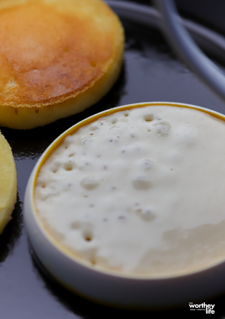 Making perfectly round mini pancakes using a silicone mold. 