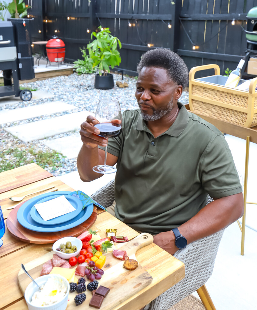 Man enjoying a glass of wine outdoors with friends