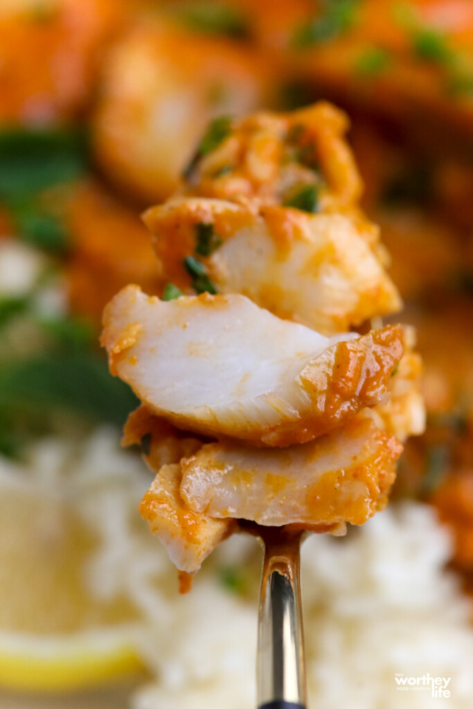 Pieces of cooked cod on a fork